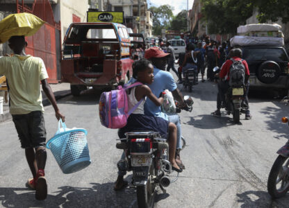 Residents flee their homes to escape gang violence in the Nazon neighborhood of Port-au-Prince, Haiti, Thursday, Nov. 14, 2024. (AP Photo/Odelyn Joseph)