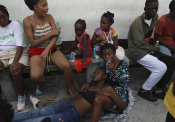 An asthmatic girl rests as she takes refuge in a private school serving as a shelter for residents fleeing gang violence in the Nazon neighborhood, in Port-au-Prince, Haiti, Thursday, Nov. 14, 2024. (AP Photo/Odelyn Joseph)