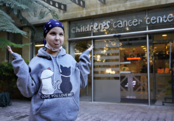 Asinat al Lahham, 9, a Syrian-Palestinian girl who escaped the war in Syria with her family and who suffers from leukaemia, gestures outside the Children's Cancer Center of Lebanon, in Beirut, Lebanon, Friday, Nov. 15, 2024. (AP Photo/Hussein Malla)