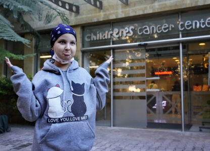 Asinat al Lahham, 9, a Syrian-Palestinian girl who escaped the war in Syria with her family and who suffers from leukaemia, gestures outside the Children's Cancer Center of Lebanon, in Beirut, Lebanon, Friday, Nov. 15, 2024. (AP Photo/Hussein Malla)