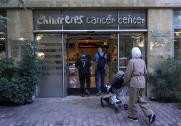 Patents with their child enter the Children's Cancer Center of Lebanon to receive their treatments, in Beirut, Lebanon, Friday, Nov. 15, 2024. (AP Photo/Hussein Malla)