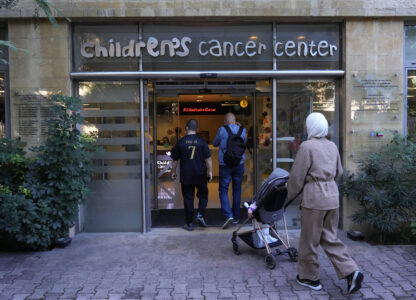 Patents with their child enter the Children's Cancer Center of Lebanon to receive their treatments, in Beirut, Lebanon, Friday, Nov. 15, 2024. (AP Photo/Hussein Malla)