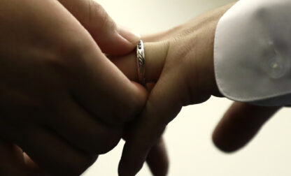 FILE - A couple exchanges wedding bands at City Hall in Philadelphia, Oct. 11, 2018. (AP Photo/Matt Rourke, File)