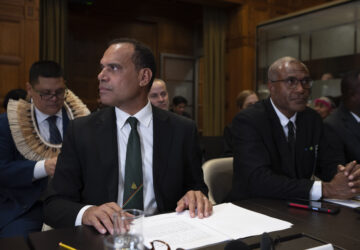 Vanuatu's special climate envoy Ralph Regenvanu prepares to speak as the International Court of Justice in The Hague, Netherlands, opens hearings into what countries worldwide are legally required to do to combat climate change and help vulnerable nations fight its devastating impact, Monday, Dec. 2, 2024. (AP Photo/Peter Dejong)