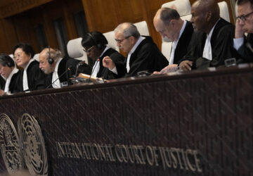 Presiding Judge Nawaf Salam, gestures as the International Court of Justice in The Hague, Netherlands, opens hearings into what countries worldwide are legally required to do to combat climate change and help vulnerable nations fight its devastating impact, Monday, Dec. 2, 2024. (AP Photo/Peter Dejong)