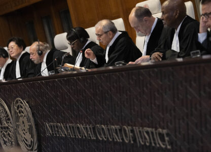 Presiding Judge Nawaf Salam, gestures as the International Court of Justice in The Hague, Netherlands, opens hearings into what countries worldwide are legally required to do to combat climate change and help vulnerable nations fight its devastating impact, Monday, Dec. 2, 2024. (AP Photo/Peter Dejong)