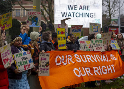 Activists protest outside the International Court of Justice, in The Hague, Netherlands, as it opens hearings into what countries worldwide are legally required to do to combat climate change and help vulnerable nations fight its devastating impact, Monday, Dec. 2, 2024. (AP Photo/Peter Dejong)