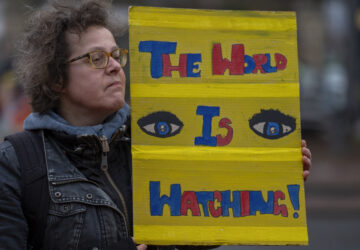 Activists protest outside the International Court of Justice, in The Hague, Netherlands, as it opens hearings into what countries worldwide are legally required to do to combat climate change and help vulnerable nations fight its devastating impact, Monday, Dec. 2, 2024. (AP Photo/Peter Dejong)