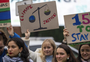 Activists protest outside the International Court of Justice, in The Hague, Netherlands, as it opens hearings into what countries worldwide are legally required to do to combat climate change and help vulnerable nations fight its devastating impact, Monday, Dec. 2, 2024. (AP Photo/Peter Dejong)