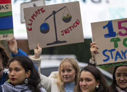 Activists protest outside the International Court of Justice, in The Hague, Netherlands, as it opens hearings into what countries worldwide are legally required to do to combat climate change and help vulnerable nations fight its devastating impact, Monday, Dec. 2, 2024. (AP Photo/Peter Dejong)