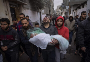 FILE - Mohammad Shouman carries the body of his daughter, Masa, who was killed in an Israeli bombardment of the Gaza Strip, during her funeral in Rafah, southern Gaza, Jan. 17, 2024. (AP Photo/Fatima Shbair, File)