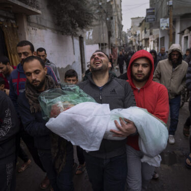 FILE - Mohammad Shouman carries the body of his daughter, Masa, who was killed in an Israeli bombardment of the Gaza Strip, during her funeral in Rafah, southern Gaza, Jan. 17, 2024. (AP Photo/Fatima Shbair, File)