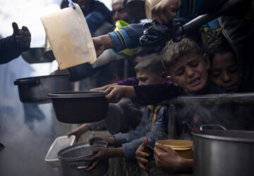 FILE - Palestinians line up for a meal in Rafah, Gaza Strip, Feb. 16, 2024. (AP Photo/Fatima Shbair, File)