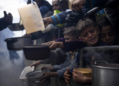 FILE - Palestinians line up for a meal in Rafah, Gaza Strip, Feb. 16, 2024. (AP Photo/Fatima Shbair, File)