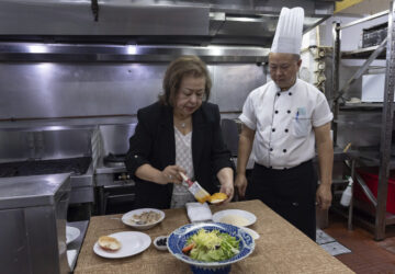 Manuela Sales da Silva Ferreira, owner of the family-run Restaurante Litoral, puts egg yolk on a crabmeat shell in a kitchen of her restaurant in Macao, on Nov. 11, 2024. (AP Photo/Anthony Kwan)