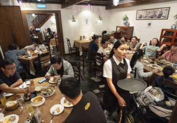 Customers dine during lunch hour at the family-run Restaurante Litoral in Macao, on Nov. 11, 2024. (AP Photo/Anthony Kwan)