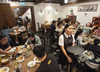 Customers dine during lunch hour at the family-run Restaurante Litoral in Macao, on Nov. 11, 2024. (AP Photo/Anthony Kwan)