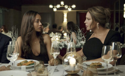 This image released by Netflix shows Karla Sofía Gascón, right, and Zoe Saldaña in a scene from 