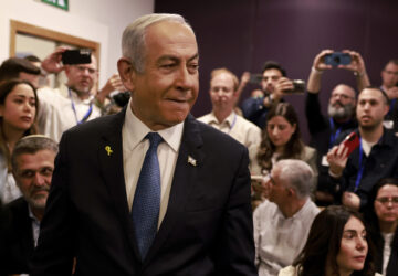 Israeli Prime Minister Benjamin Netanyahu arrives at the district court for his long-running trial for alleged corruption, in Tel Aviv, Israel, Tuesday, Dec. 10, 2024. (Menahem Kahana/Pool Photo via AP)