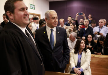 Israeli Prime Minister Benjamin Netanyahu, center, arrives at the district court for his long-running trial for alleged corruption, in Tel Aviv, Israel, Tuesday, Dec. 10, 2024. (Menahem Kahana/Pool Photo via AP)