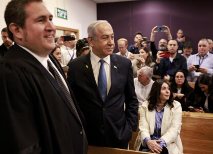 Israeli Prime Minister Benjamin Netanyahu, center, arrives at the district court for his long-running trial for alleged corruption, in Tel Aviv, Israel, Tuesday, Dec. 10, 2024. (Menahem Kahana/Pool Photo via AP)