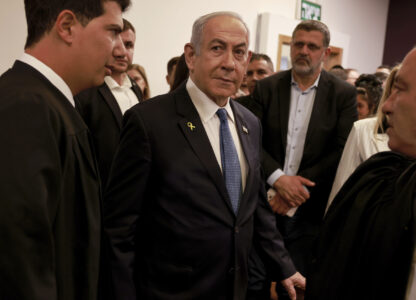 Israeli Prime Minister Benjamin Netanyahu, center, arrives at the district court for his long-running trial for alleged corruption, in Tel Aviv, Israel, Tuesday, Dec. 10, 2024. (Menahem Kahana/Pool Photo via AP)