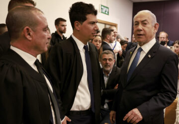 Israeli Prime Minister Benjamin Netanyahu, right, arrives at the district court for his long-running trial for alleged corruption, in Tel Aviv, Israel, Tuesday, Dec. 10, 2024. (Menahem Kahana/Pool Photo via AP)