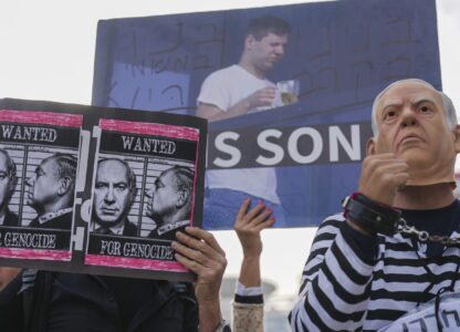 Demonstrators protest against Prime Minster Benjamin Netanyahu outside the court in Tel Aviv Tuesday Dec. 10, 2024. Netanyahu is set to take the stand on Tuesday in his long-running trial for alleged corruption.(AP Photo/Ariel Schalit)