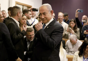 Israeli Prime Minister Benjamin Netanyahu arrives at the district court in Tel Aviv for his long-running trial for alleged corruption, in Tel Aviv, Israel, Tuesday, Dec. 10, 2024. (Menahem Kahana/Pool Photo via AP)