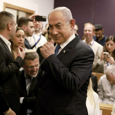 Israeli Prime Minister Benjamin Netanyahu arrives at the district court in Tel Aviv for his long-running trial for alleged corruption, in Tel Aviv, Israel, Tuesday, Dec. 10, 2024. (Menahem Kahana/Pool Photo via AP)