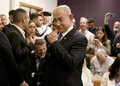 Israeli Prime Minister Benjamin Netanyahu arrives at the district court in Tel Aviv for his long-running trial for alleged corruption, in Tel Aviv, Israel, Tuesday, Dec. 10, 2024. (Menahem Kahana/Pool Photo via AP)