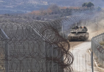 An Israeli army tank maneuvers near the so-called Alpha Line that separates the Israeli-annexed Golan Heights from Syria, in the town of Majdal Shams, Wednesday, Dec. 11, 2024. (AP Photo/Matias Delacroix)