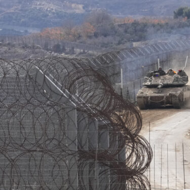 An Israeli army tank maneuvers near the so-called Alpha Line that separates the Israeli-annexed Golan Heights from Syria, in the town of Majdal Shams, Wednesday, Dec. 11, 2024. (AP Photo/Matias Delacroix)