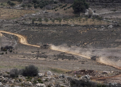 Israeli tanks cross the security fence moving towards the so-called Alpha Line that separates the Israeli-annexed Golan Heights from Syria, in the town of Majdal Shams, Wednesday, Dec. 11, 2024. (AP Photo/Matias Delacroix)