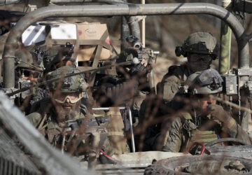 Israeli soldiers stand on an armoured vehicle before crossing the security fence, moving towards the so-called Alpha Line that separates the Israeli-annexed Golan Heights from Syria, in the town of Majdal Shams, Wednesday, Dec. 11, 2024. (AP Photo/Matias Delacroix)