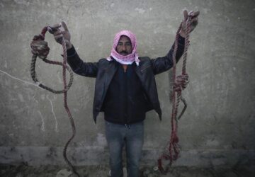 A man shows two ropes tied in the shape of nooses, found in the infamous Saydnaya military prison, just north of Damascus, Syria, Monday, Dec. 9, 2024. Crowds are gathering to enter the prison, known as the 