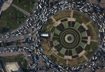 An arial view shows central Damascus' Umayyad Square as Syrians display the revolutionary flag to celebrate on the second day of the insurgents' takeover of the city in Damascus, Syria, on Monday, Dec. 9, 2024. (AP Photo/Ghaith Alsayed)