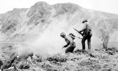 FILE - A U.S. squad armed with guns and hand grenades closes in on Japanese holdouts entrenched in dugouts during World War II on Attu Island, Alaska, in June 1943. (U.S. Army via AP, File)