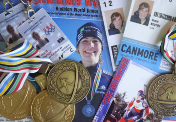 Biathlon competition medals, credentials, and media clippings belonging to Grace Boutot, silver medalist in Youth World Championships in 2009, are displayed for a photograph at her home, Oct. 17, 2024, in Boston. (AP Photo/Steven Senne)