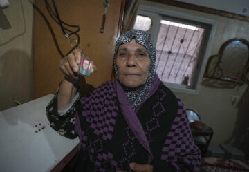 Sabah Alghrabli shows a key chain with a picture of her husband, Mahmoud Alghrabli, at her home in Khan Younis, Gaza Strip, Nov. 21, 2024. (AP Photo/Abdel Kareem Hana)