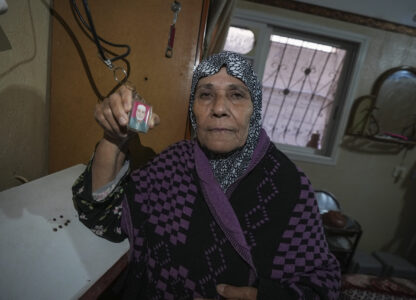 Sabah Alghrabli shows a key chain with a picture of her husband, Mahmoud Alghrabli, at her home in Khan Younis, Gaza Strip, Nov. 21, 2024. (AP Photo/Abdel Kareem Hana)