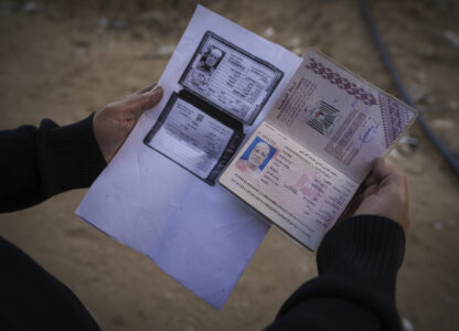 Sabah Alghrabli shows some documents of her husband, Mahmoud Alghrabli, at her home in Khan Younis, Gaza Strip, Nov. 21, 2024. (AP Photo/Abdel Kareem Hana)