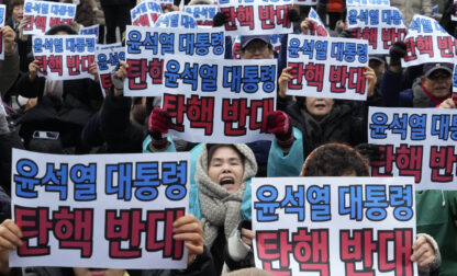 Supporters for impeached South Korean President Yoon Suk Yeol stage a rally against his impeachment near the Constitutional Court in Seoul, South Korea, Monday, Dec. 16, 2024. The signs read 