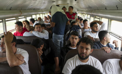 Honduran migrants who were deported from the U.S. sit on a bus after deplaning at Ramon Villeda Morales Airport in San Pedro Sula, Honduras, Wednesday, Dec. 4, 2024. (AP Photo/Moises Castillo)