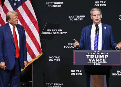 FILE - Republican presidential nominee former President Donald Trump, left, listens as investor Scott Bessent speaks on the economy in Asheville, N.C., Aug. 14, 2024. (AP Photo/Matt Kelley, File)