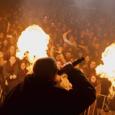 The crowd reacts to the performance of rap band PVNCH during the presentation of the music album Epoch, a collaboration between Ukrainian artists and the 3rd Assault Brigade, in Kyiv, Ukraine, Saturday, Dec. 7, 2024. (AP Photo/Alex Babenko)