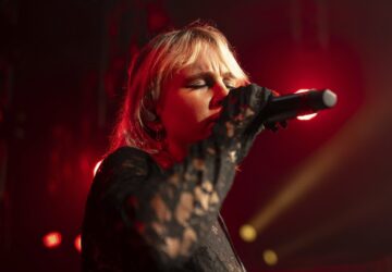 Iryna Panchuk, solo singer of indie rock band Renie Cares sings during the presentation of the music album Epoch, a collaboration between Ukrainian artists and the 3rd Assault Brigade, in Kyiv, Ukraine, Saturday, Dec. 7, 2024. (AP Photo/Alex Babenko)