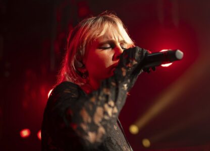 Iryna Panchuk, solo singer of indie rock band Renie Cares sings during the presentation of the music album Epoch, a collaboration between Ukrainian artists and the 3rd Assault Brigade, in Kyiv, Ukraine, Saturday, Dec. 7, 2024. (AP Photo/Alex Babenko)