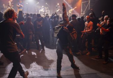 Ukrainian serviceman dance during the presentation of the music album Epoch, a collaboration between Ukrainian artists and the 3rd Assault Brigade, in Kyiv, Ukraine, Saturday, Dec. 7, 2024. (AP Photo/Alex Babenko)