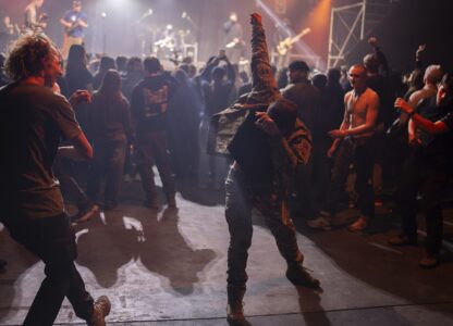 Ukrainian serviceman dance during the presentation of the music album Epoch, a collaboration between Ukrainian artists and the 3rd Assault Brigade, in Kyiv, Ukraine, Saturday, Dec. 7, 2024. (AP Photo/Alex Babenko)